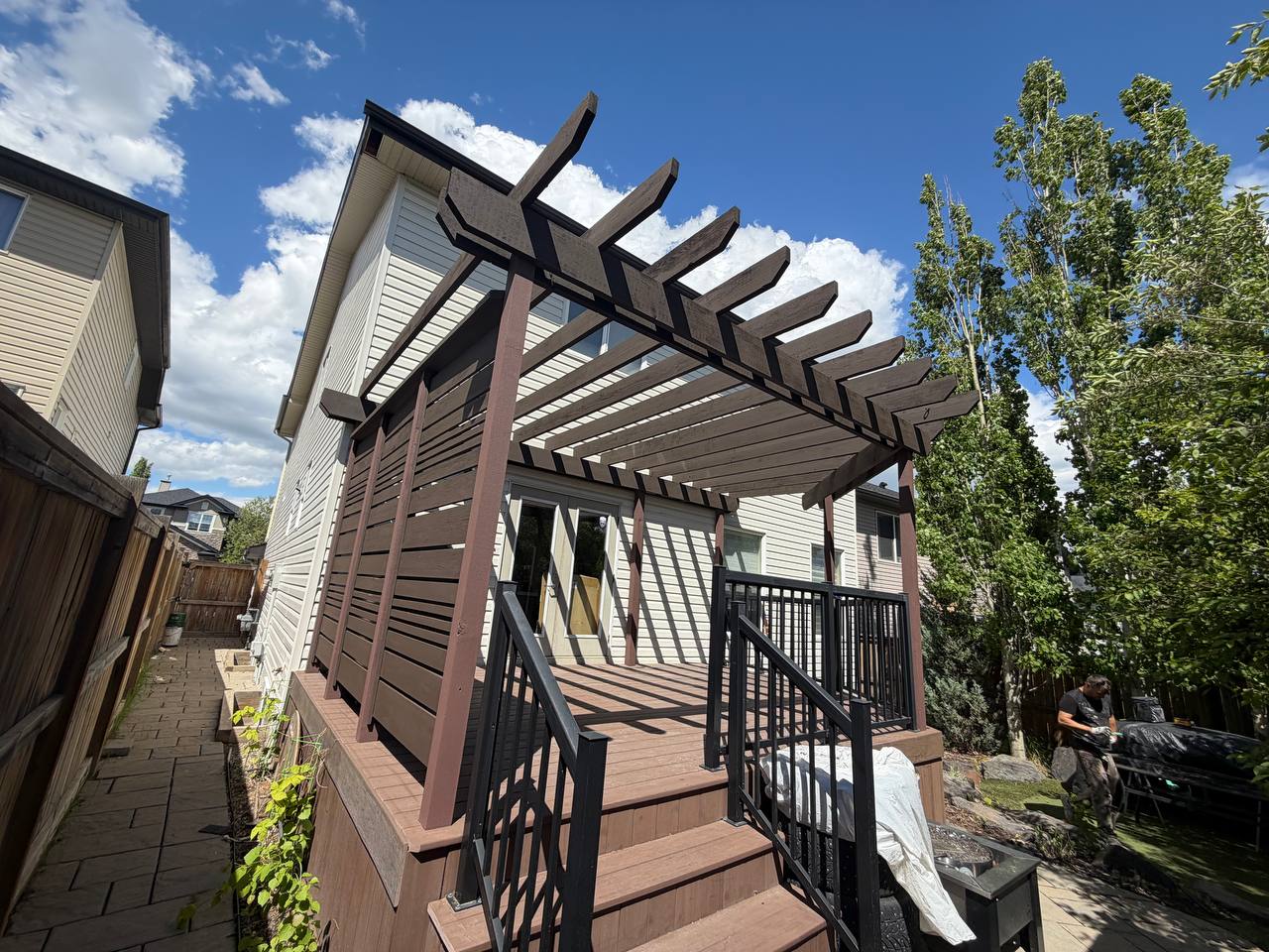 Calgary deck staining with pergola and privacy screen by Fix On Call