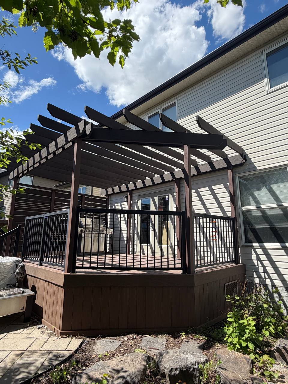 Restained Calgary deck with pergola railing and exterior wood finish