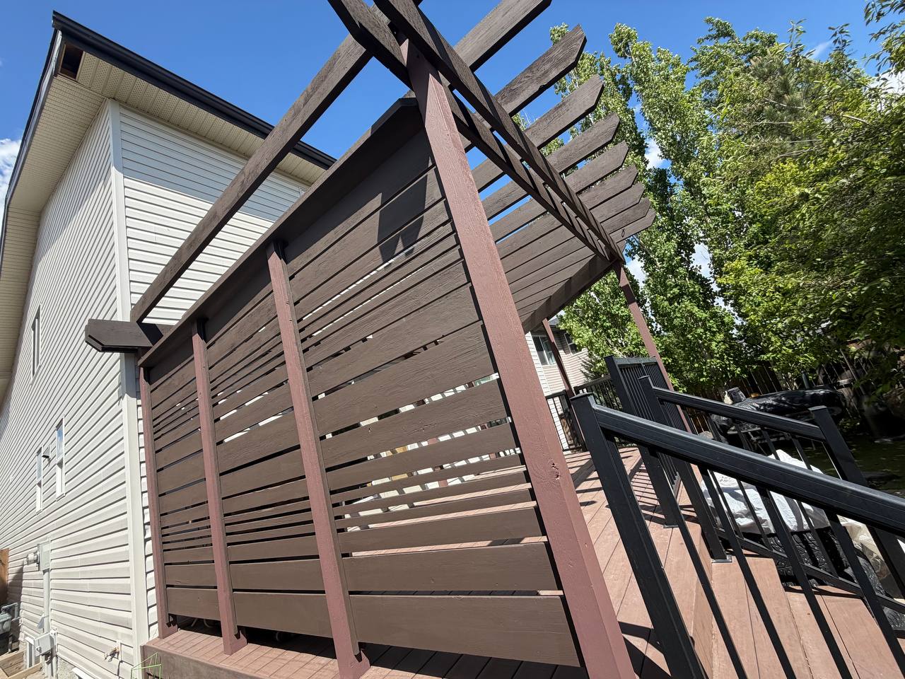 Deck and fence privacy screen staining in Calgary with pergola beams