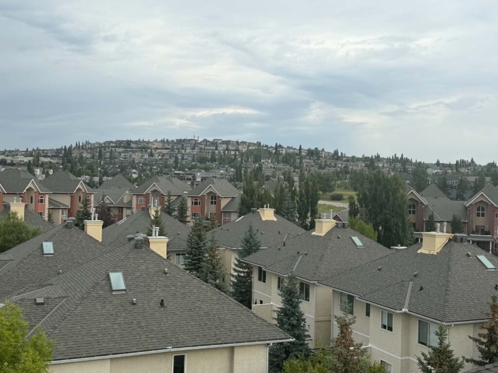 Rooftop view over a row of homes with cream stucco chimneys